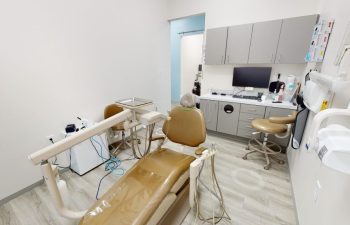 Treatment room with a dental chair and equipment at Buford Family Dental.