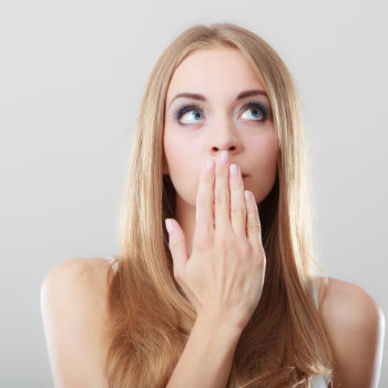 Young Woman Covering Her Mouth With Her Hand