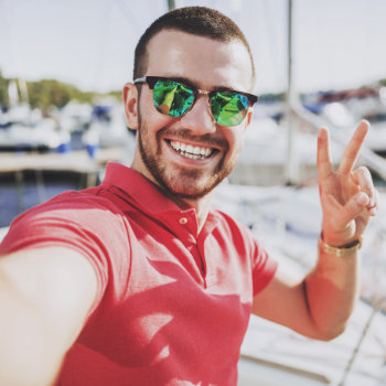 Young Happy Smiling Man wearing Sunglasses