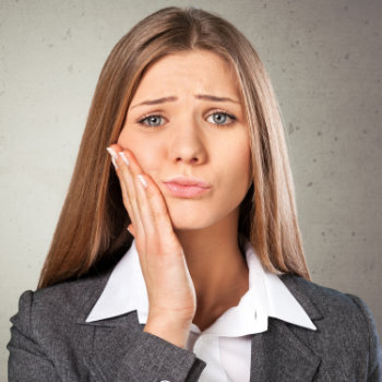 attractive blonde suffering from gum pain