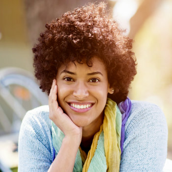 cheerful african american woman touching her cheek