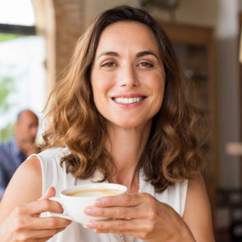 smiling mature woman with a cup of coffee